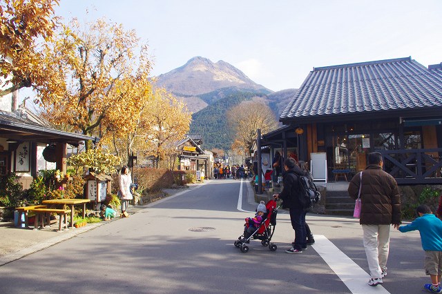 This is Yunotsubo Street in Yufuin, Oita, Japan. Both sides of the street are lined with stores and restaurants where tourists enjoy strolling. Mt. Yufudake is in the background.