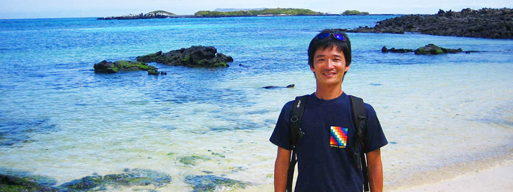 Makoto Tanaka, president of Trip Insight Corp. smiles as he stands on a beach on Albemarle Island (Isla Isabela) in the Galapagos Islands, Ecuador. The sea is crystal clear and very beautiful.